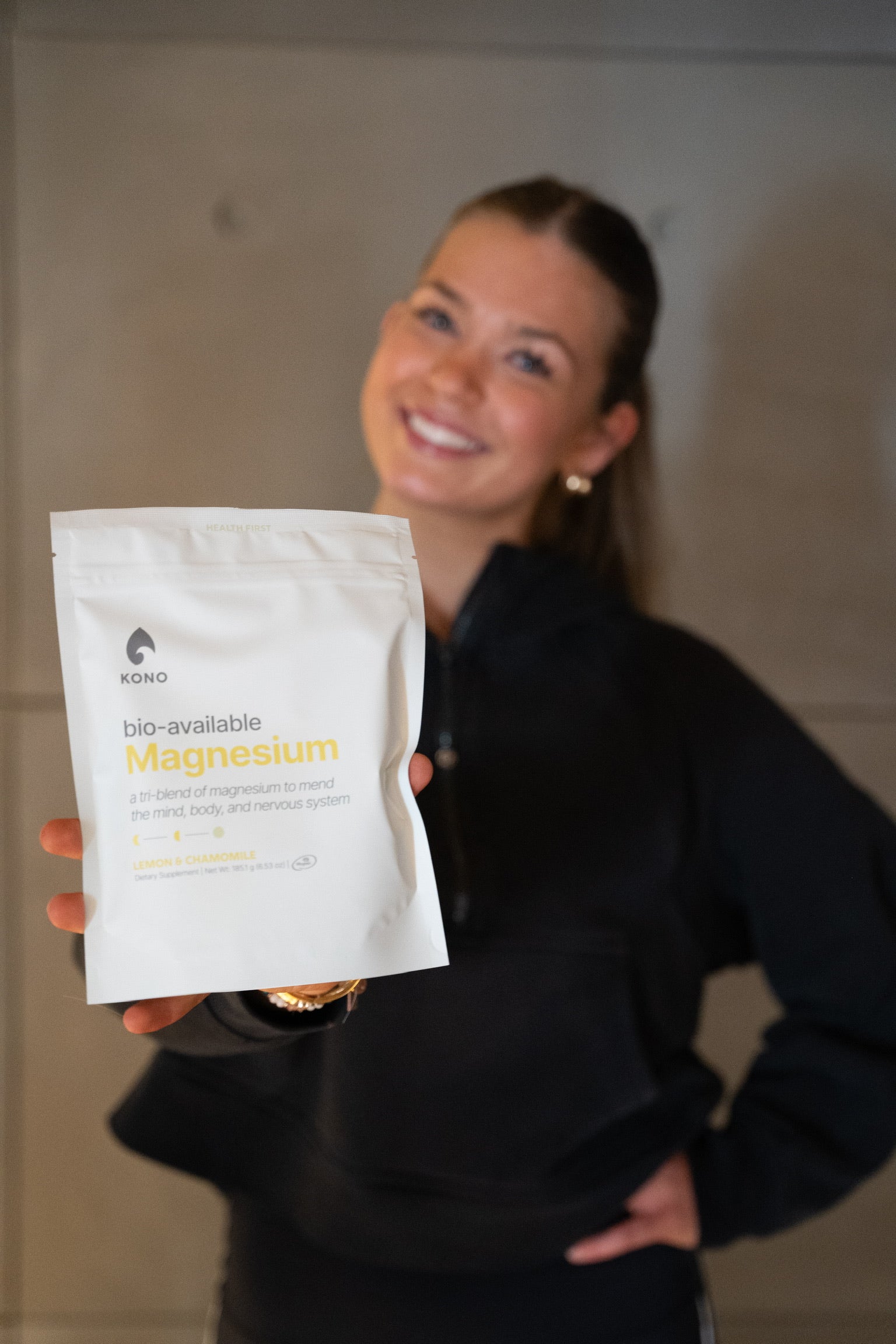 lifestyle product photo—person presenting KONO bioavailable magnesium for mind, body, and nervous system support