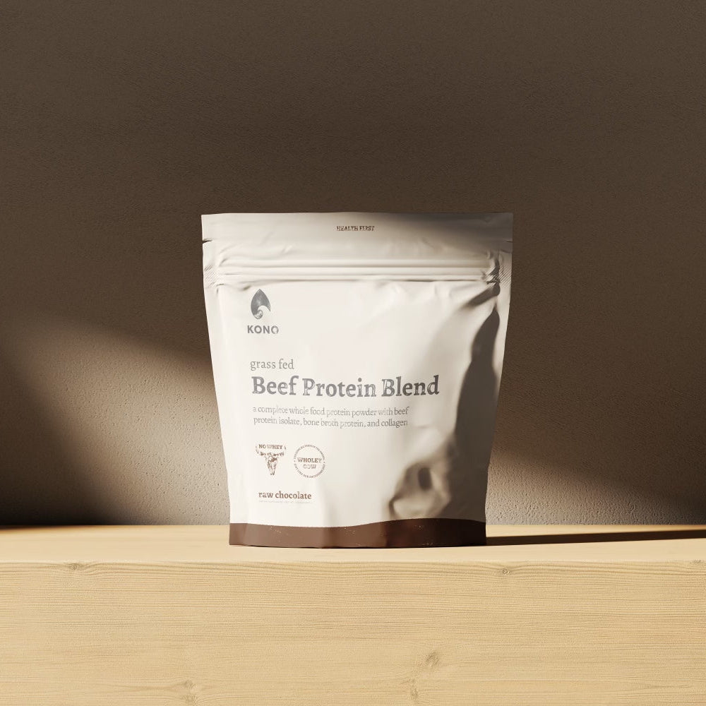 KONO Beef Protein Blend - raw chocolate pouch on a wooden shelf in soft natural light.