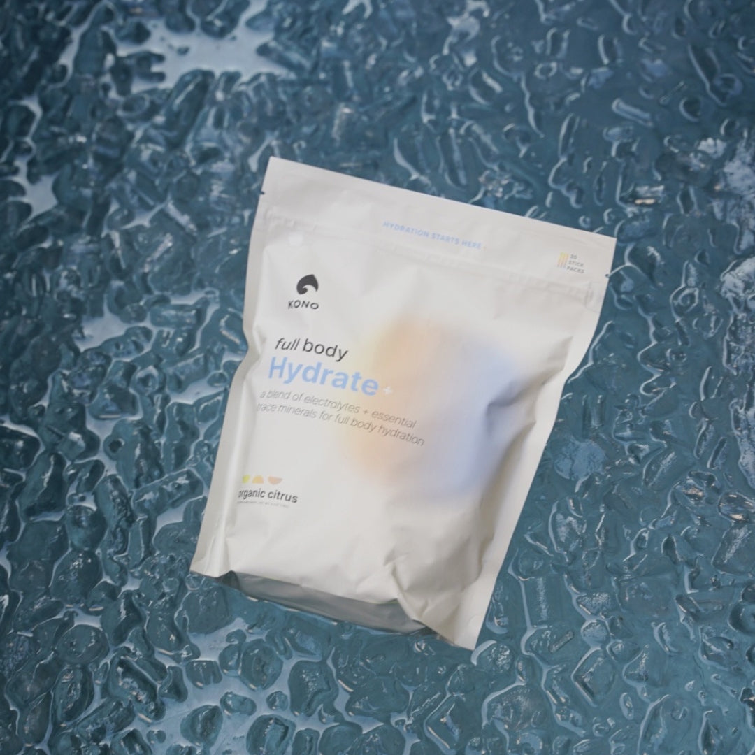 KONO full body Hydrate+ organic citrus electrolyte drink mix pouch on Ice—hydration powder with trace minerals.