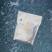KONO full body Hydrate+ organic citrus electrolyte drink mix pouch on Ice—hydration powder with trace minerals.