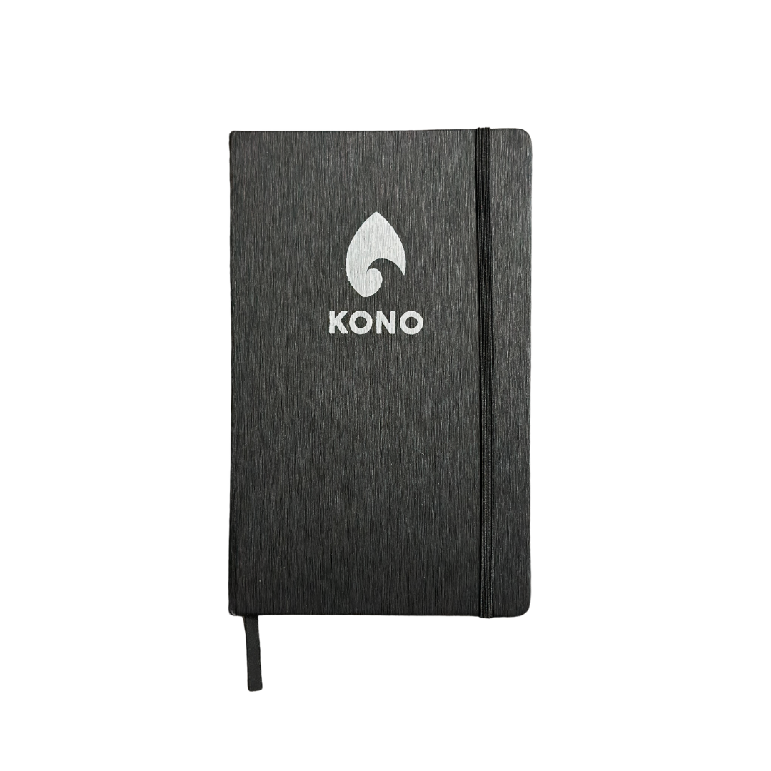 Black KONO notebook isolated on transparent background, front cover with elastic band—clean ecommerce product photo
