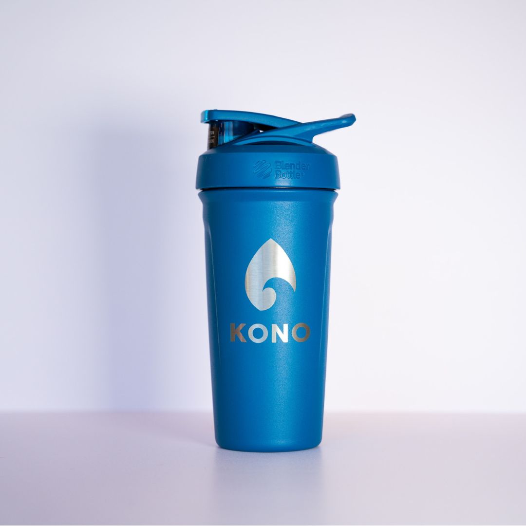 Blue shaker: Blue KONO BlenderBottle shaker cup with flip cap and metal logo, durable gym protein mixer photographed against a white background.