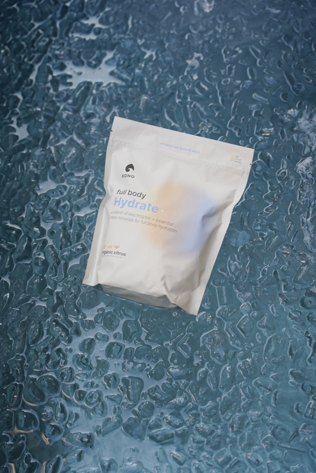 minimalist photo of KONO Hydrate+ full body hydration powder on icy surface, chill hydration theme