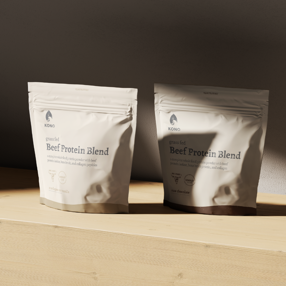 Two KONO Beef Protein Blend pouches on a wooden shelf in soft natural light.
