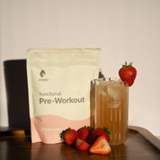 KONO Functional Pre-Workout Strawberries—pouch with an iced pre-workout drink and fresh strawberries on a tray.