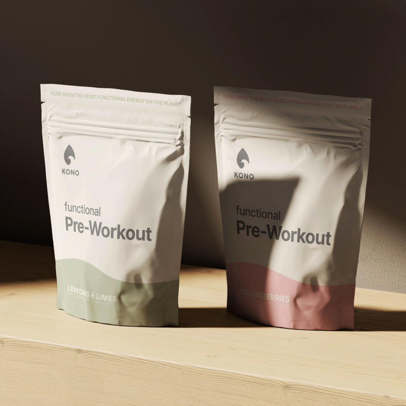 KONO Functional Pre-Workout drink mix—Lemons & Limes and Strawberries flavors, two stand-up pouches on a wooden shelf, minimalist product photo.