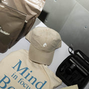 KONO khaki dad hat with embroidered logo styled on a table with KONO whey protein pouches and accessories—lifestyle flat lay.