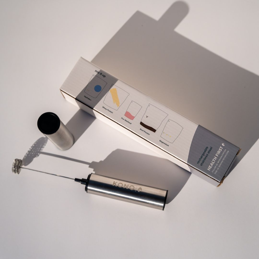 KONO premium milk frother set—stainless steel drink mixer with whisk and cap beside retail box on a white background
